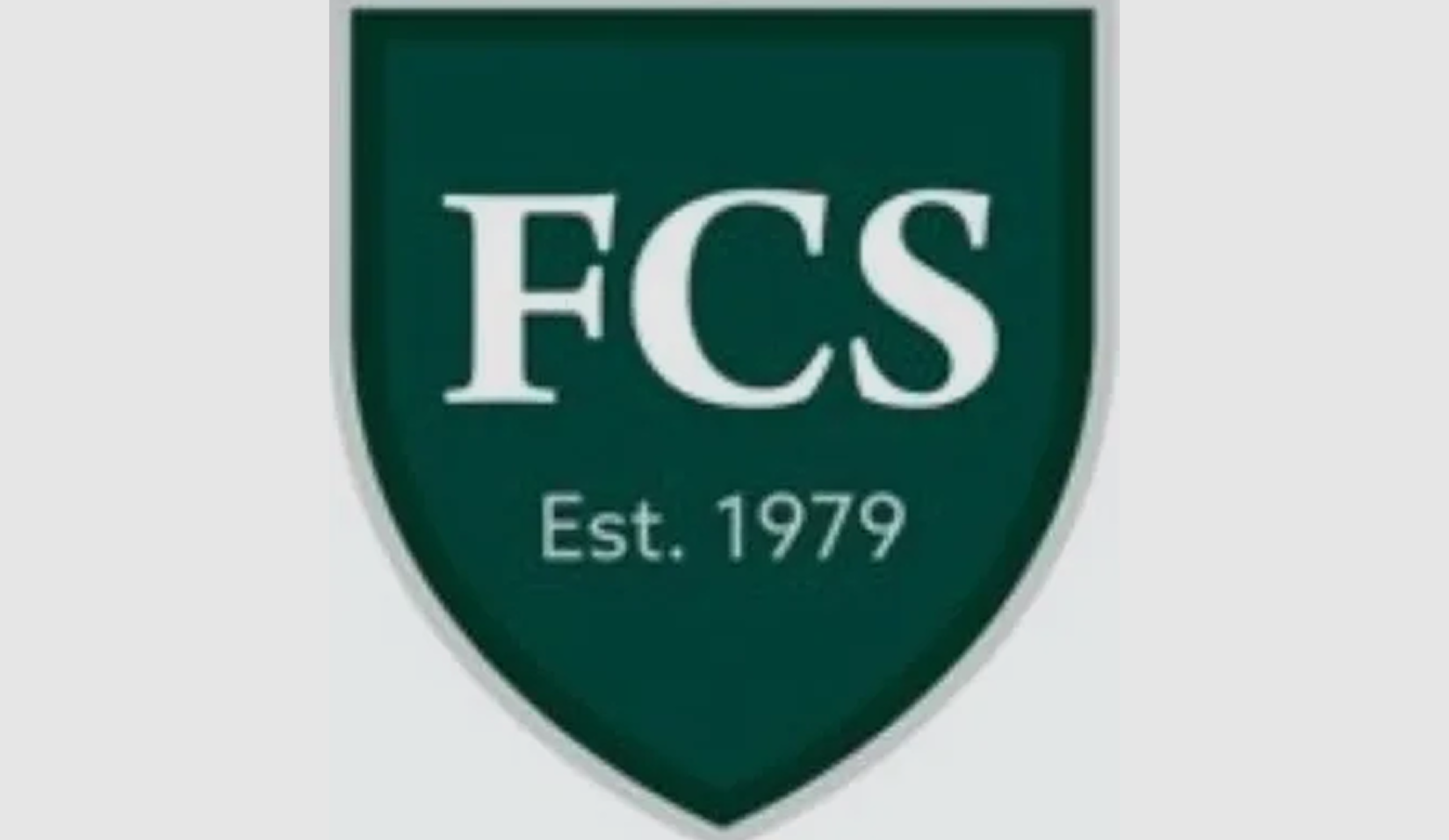 Green shield with "FCS Est. 1979" text.