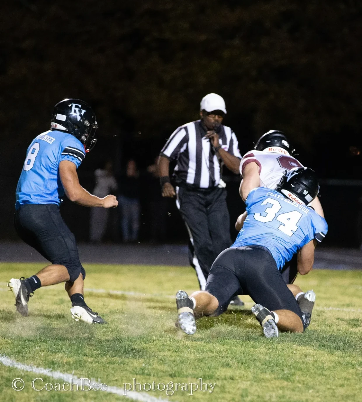 Football players tackling during a game.