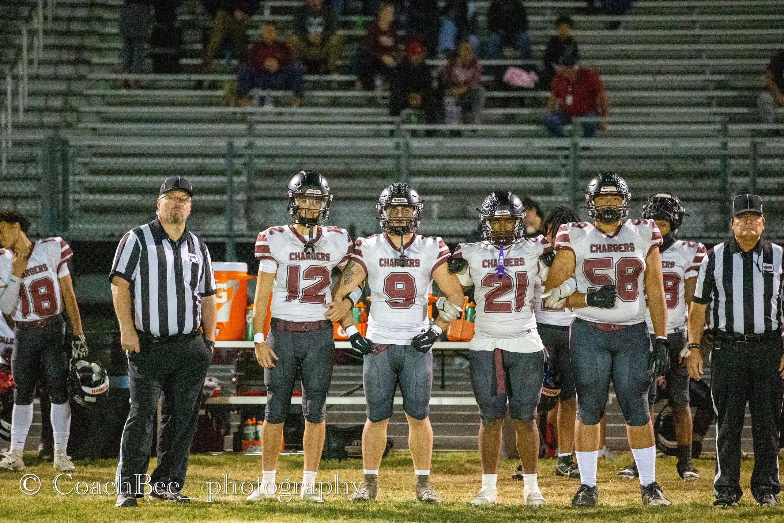 Football players and referees on the field.