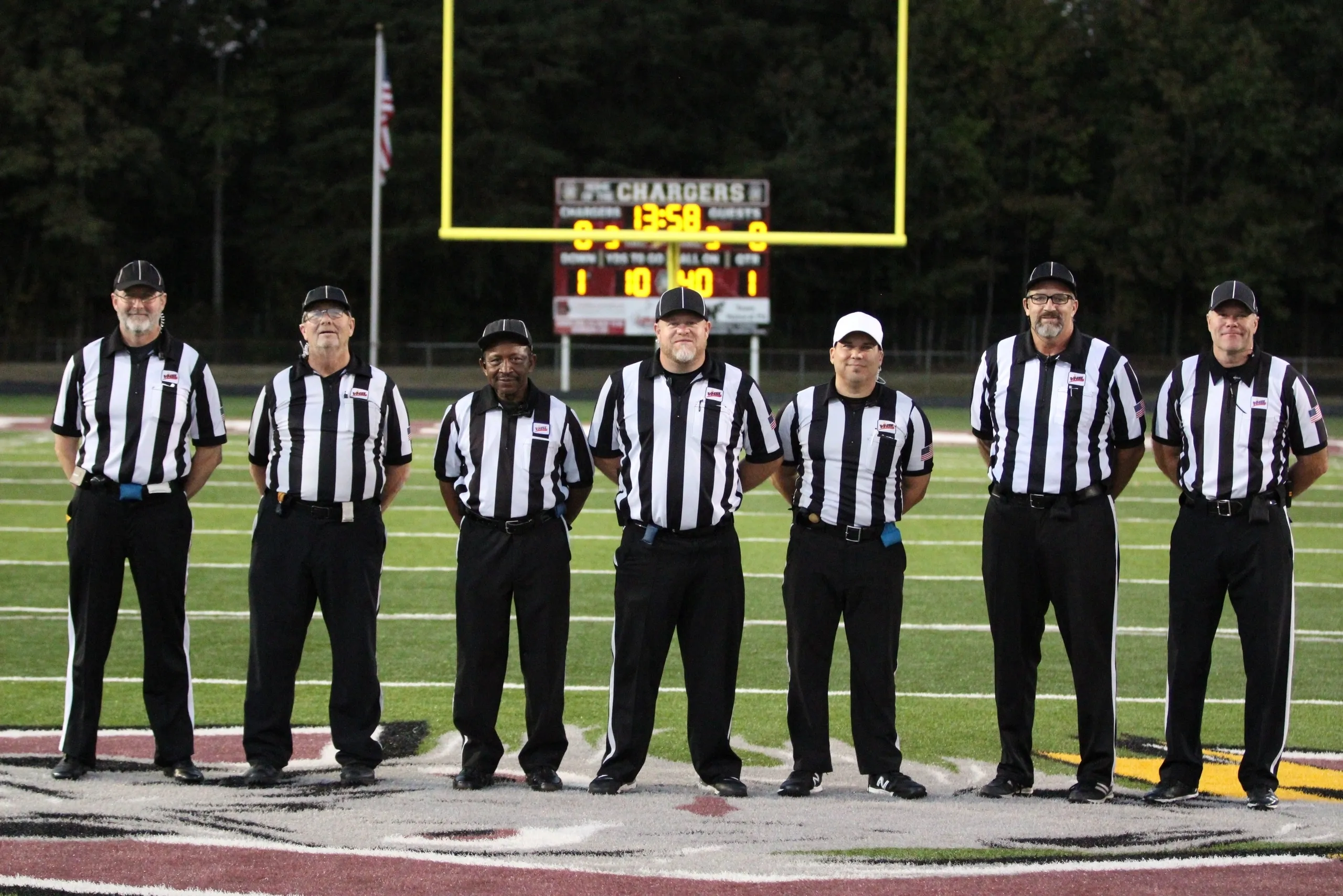 Football referees standing on the field.