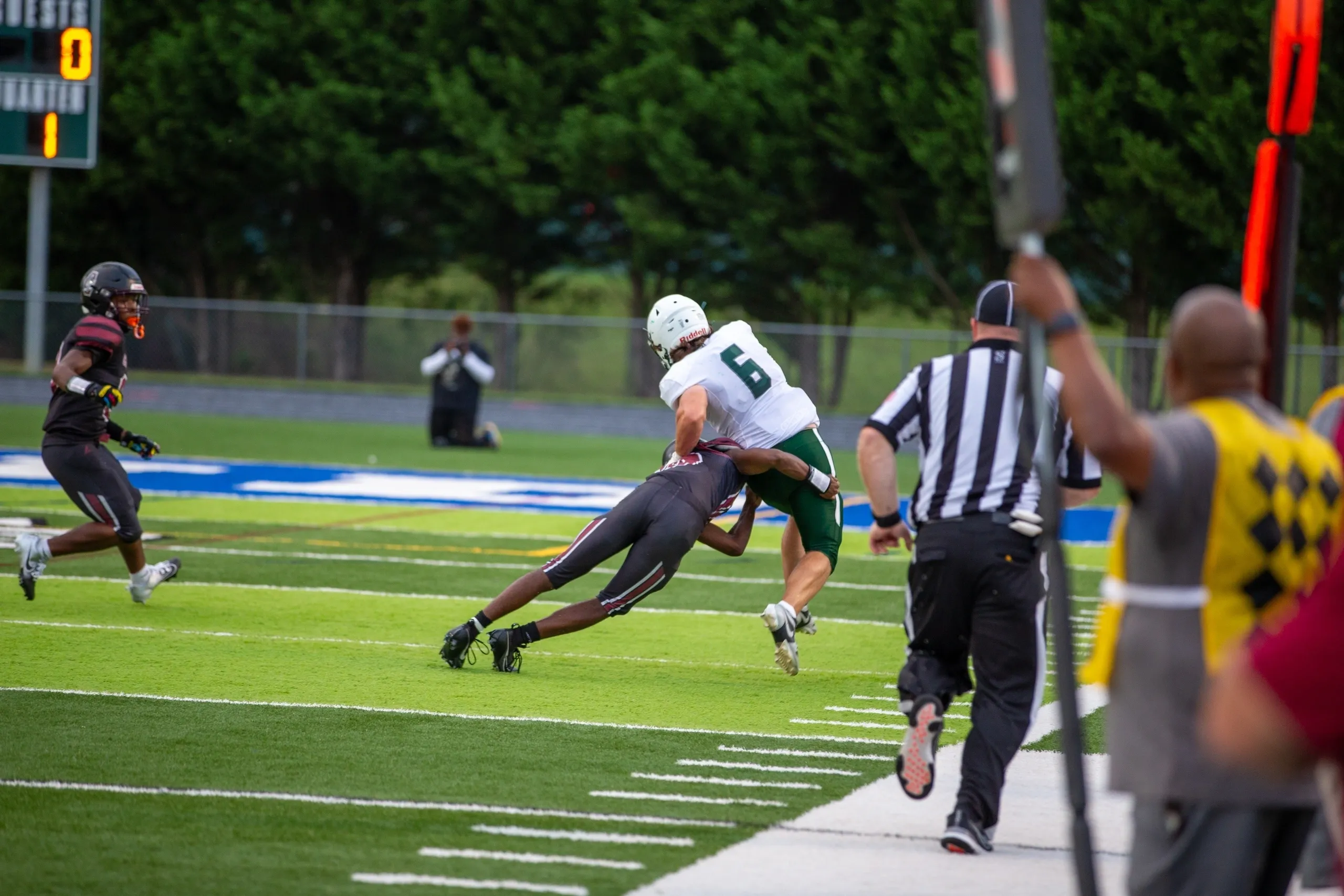 Football tackle near the sideline.