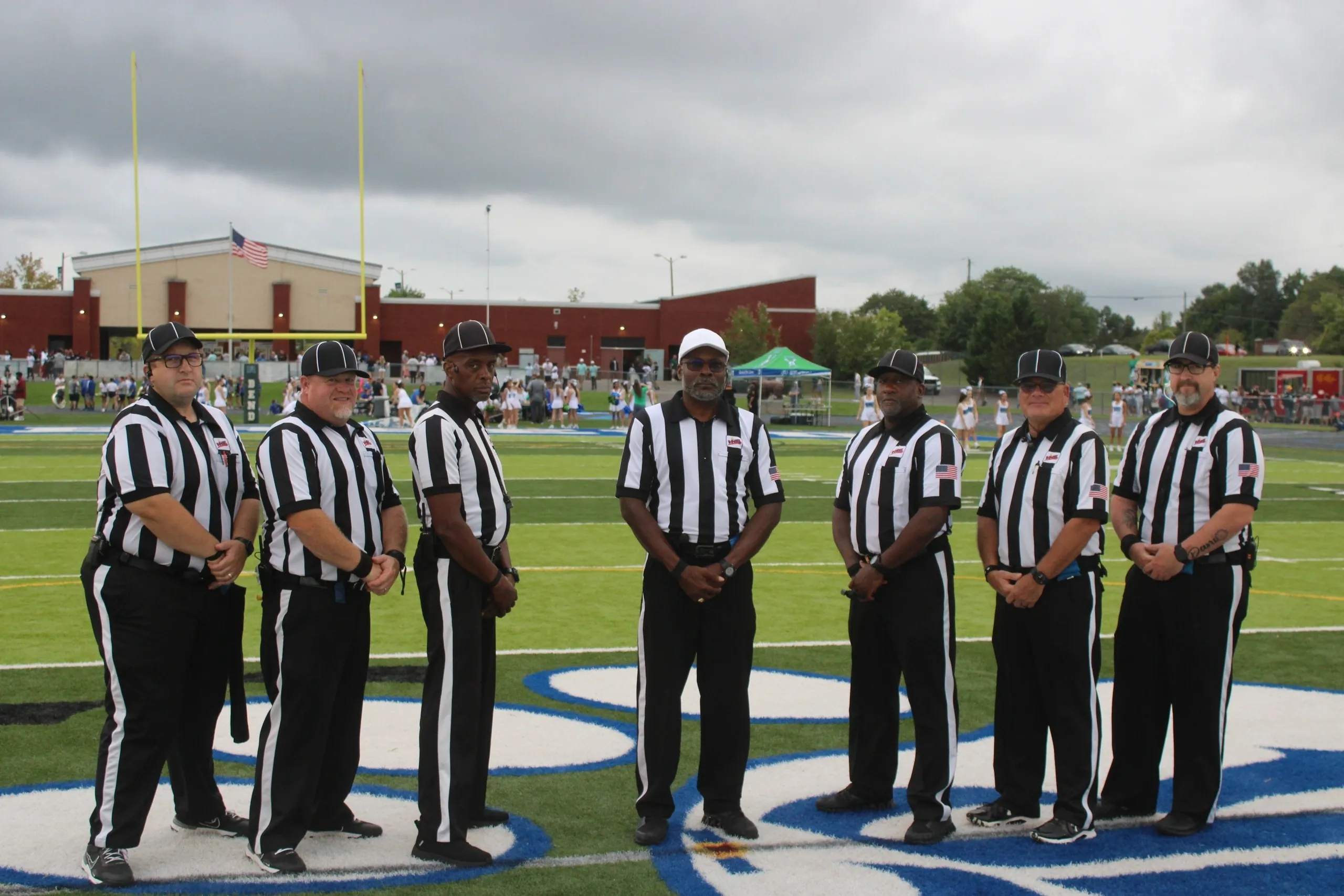 Football referees standing on the field.