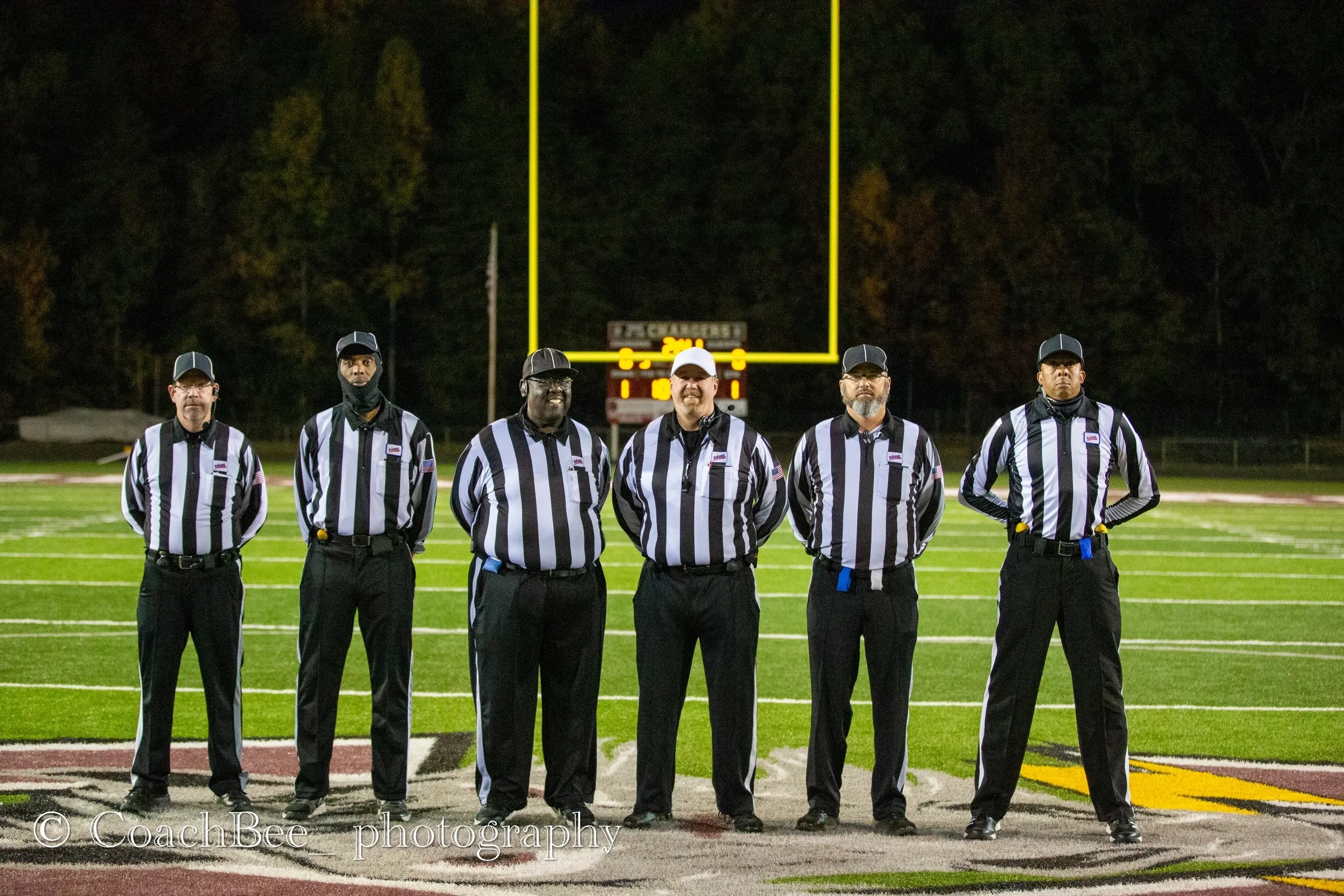 Football referees standing on the field.